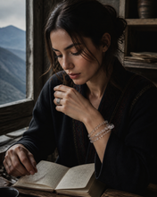 Load image into Gallery viewer, NORBU OBJECTS product image direction: a neck-worn line with a central pendant or focal detail; clear and translucent tones; deep highland light; a map archivist in a quiet Lhasa guesthouse; collector archive.