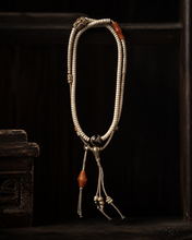 Load image into Gallery viewer, A Quiet Return beaded bracelet with pale beads and warm orange accent — image 03