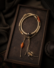 Load image into Gallery viewer, A Quiet Return beaded bracelet with pale beads and warm orange accent — image 06