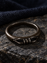 Load image into Gallery viewer, The Unbroken Tibetan Dorje statement ring in a cinematic dark setting.