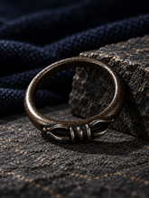 Load image into Gallery viewer, The Unbroken ring displayed in a curated jewelry setting.
