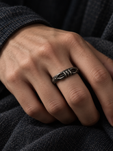 Load image into Gallery viewer, The Unbroken statement ring worn beside a dark sleeve.
